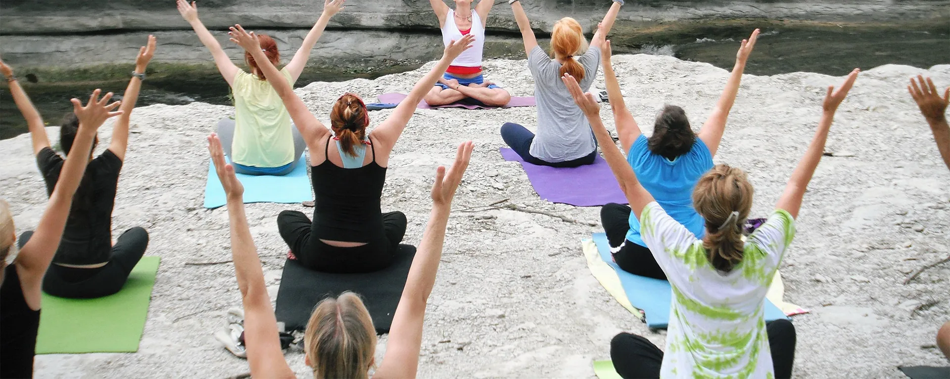 An outdoor Pilates class stretching together